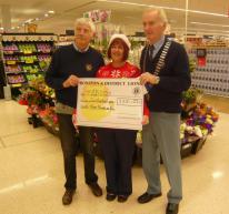 Lion President Ed with Lion Barry presenting Kim from Tesco with 233 cheque for Diabetes UK