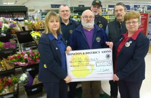 Julia Giles and Alison McKenzie receive 500 cheque from Lion Brian Richards
