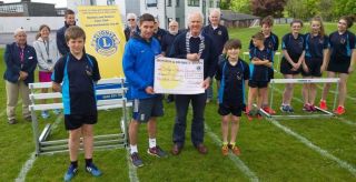 Lion President Steve presenting Andy Taylor Head of Sport & PE with 500