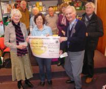 Lions and Lions Ladies give 100 each to Honiton Foodbank
