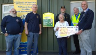 Lion President Steve donates £400 towards village defibrillator