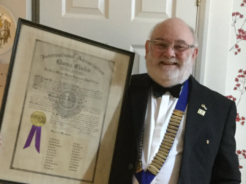 Brian Richards holding the original charter from 1977