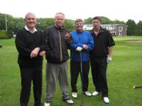 Four brave windswept golfers