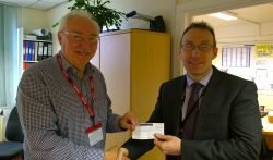 Lion Bob presents £100 to Matt Burrell from Honiton College for Senior citizens xmas party