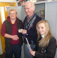 Lion President presenting £100 cheque to Students