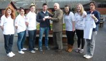 Lion Ron Webb presenting cash and T Shirts to Andy Taylor and his PE Sports group
