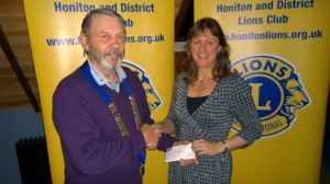 Lion president John awarding Laura with 250