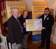 Lion President Steve presenting £1000 cheque to Free Wheelers Dan and Kevin