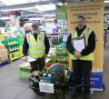 Lions Bill and John with the wheelbarrow for of garden equipment