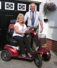 Lion President Steve Guilbert presenting mobility scooter to Mrs Gilson